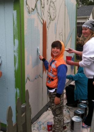 Eli smiling while painting