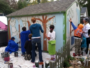 Kids filling in the mural with paint